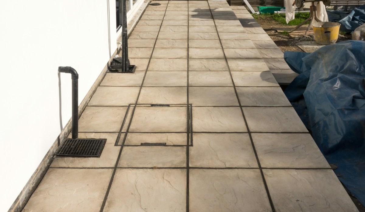 Newly finished backyard patio surface laid out behind a residential home