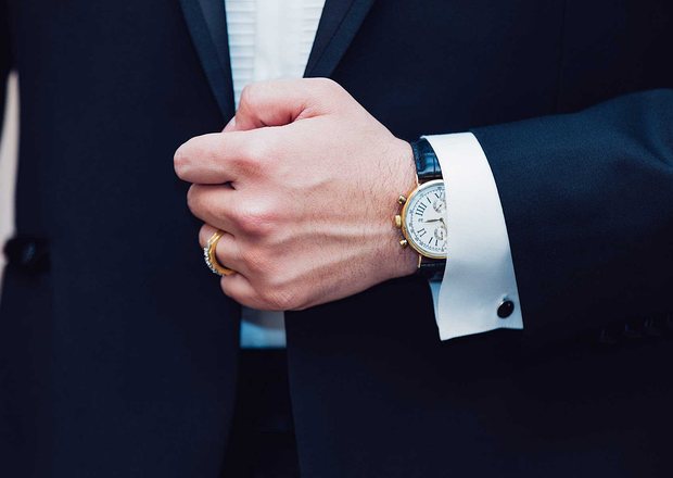 An attorney adjusting his cuff before a hearing
