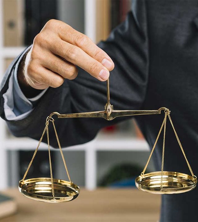 Attorney weighing the scales of justice in chambers